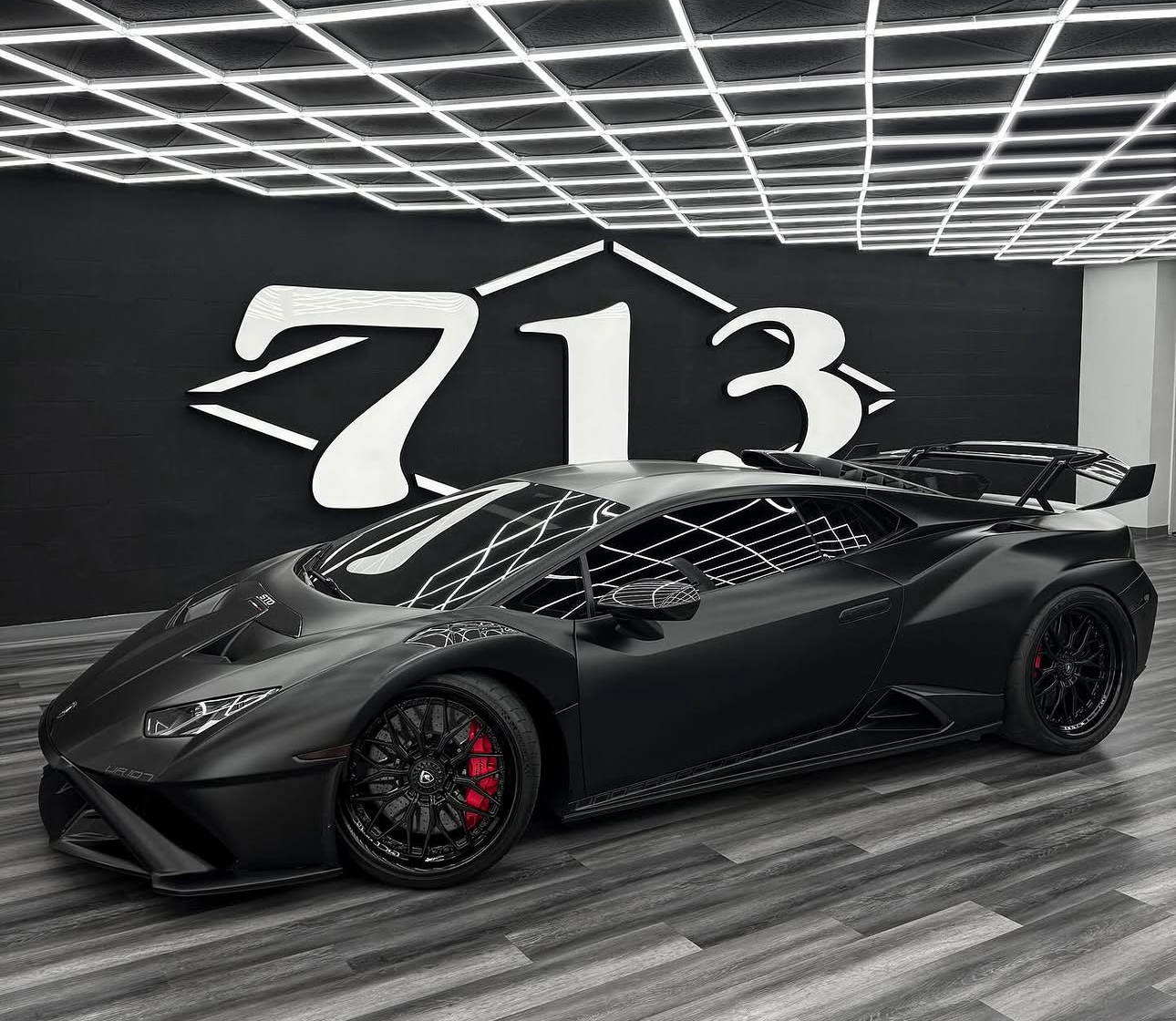 Matte black Lamborghini displayed inside 713 Motors