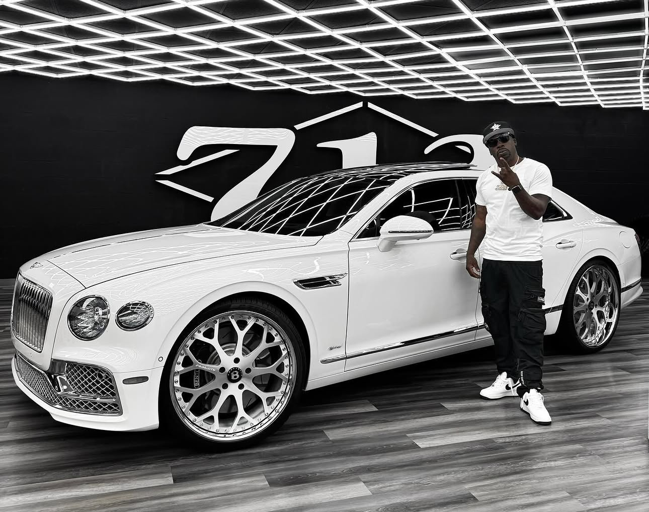 White Bentley displayed inside 713 Motors
