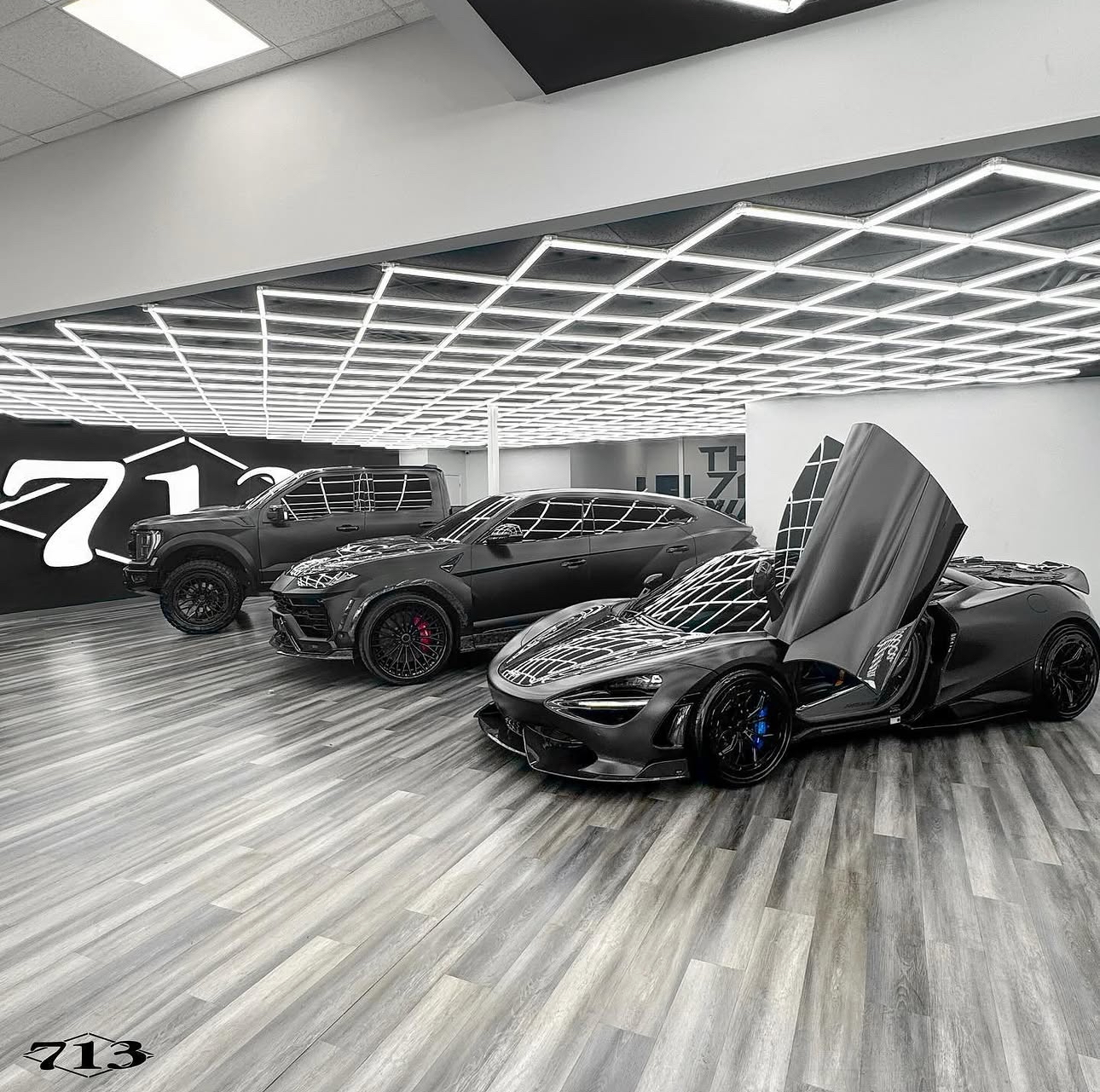 McLaren and Lamborghini Urus inside the 713 Motors showroom